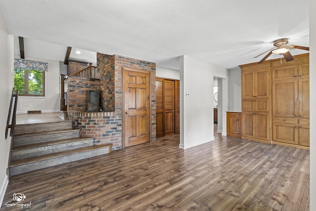 509 Apollo Dr, Joliet, IL 60435 - unfurnished living room with ceiling fan, wood finished floors, stairway, a textured ceiling, and brick wall