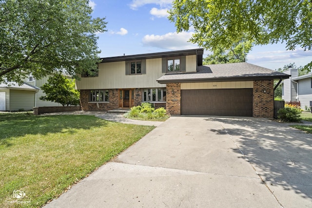 509 Apollo Dr, Joliet, IL 60435 - view of front of property with brick siding, a front yard, concrete driveway, and an attached garage