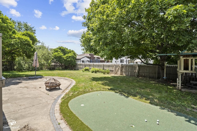 509 Apollo Dr, Joliet, IL 60435 - fenced backyard with an outdoor fire pit, a patio area, and an area to practice putting