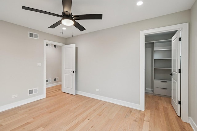 2700 Fontana Dr, Glenview, IL 60025 - unfurnished bedroom with a spacious closet, light wood-type flooring, recessed lighting, a closet, and a ceiling fan