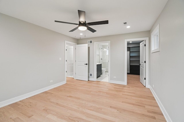 2700 Fontana Dr, Glenview, IL 60025 - unfurnished bedroom with a spacious closet, light wood finished floors, recessed lighting, ensuite bath, and a ceiling fan