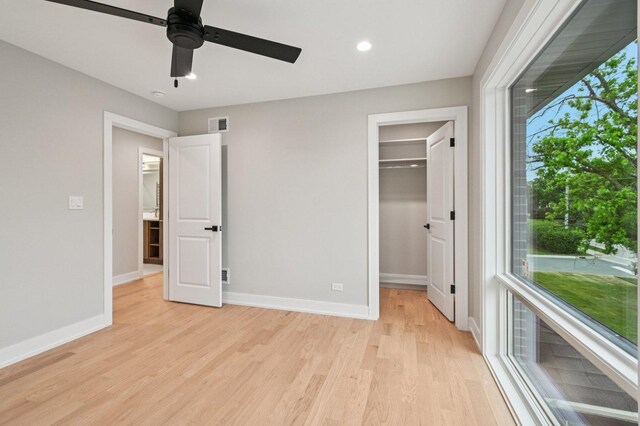 2700 Fontana Dr, Glenview, IL 60025 - unfurnished bedroom featuring light wood-type flooring, multiple windows, a spacious closet, recessed lighting, and a ceiling fan