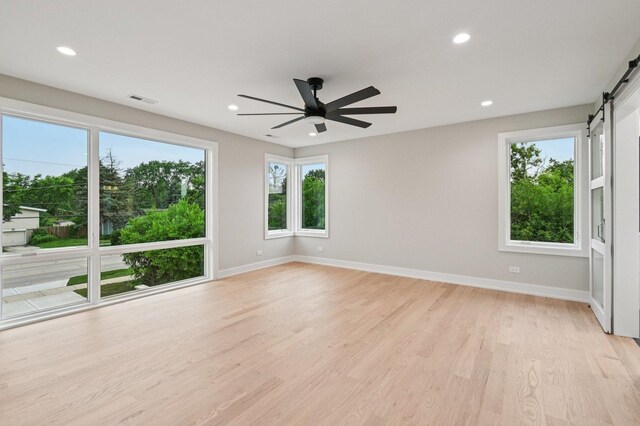 2700 Fontana Dr, Glenview, IL 60025 - spare room with a barn door, light wood finished floors, a ceiling fan, and recessed lighting