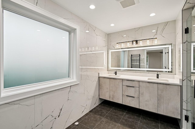 2700 Fontana Dr, Glenview, IL 60025 - bathroom featuring tile walls, double vanity, tile patterned floors, recessed lighting, and a marble finish shower