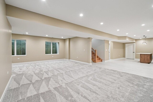 2700 Fontana Dr, Glenview, IL 60025 - below grade area featuring light colored carpet, stairway, and recessed lighting