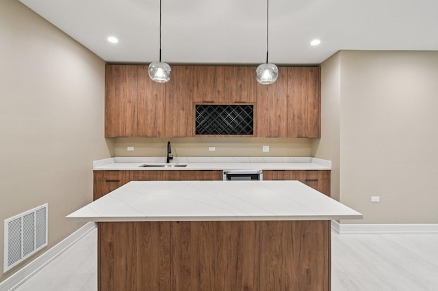 2700 Fontana Dr, Glenview, IL 60025 - kitchen featuring brown cabinets, modern cabinets, hanging light fixtures, a center island, and recessed lighting