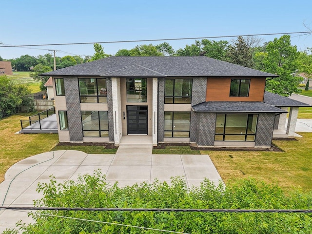 2700 Fontana Dr, Glenview, IL 60025 - contemporary house featuring a front yard, roof with shingles, and brick siding
