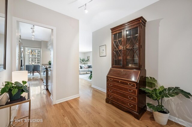 1325 N State Pkwy Unit 7A, Chicago, IL 60610 - hallway featuring light wood finished floors and rail lighting