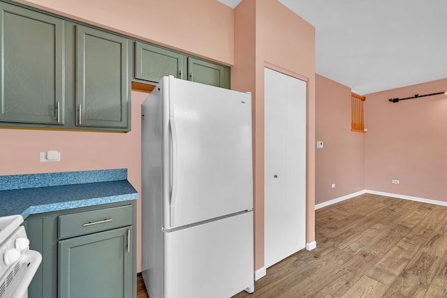 1423 Red Top Ln, Minooka, IL 60447 - kitchen with freestanding refrigerator, green cabinets, stove, and light wood-style floors