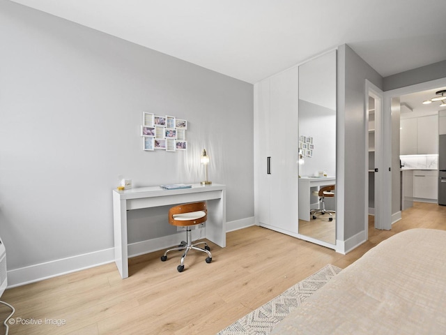 1455 N Sandburg Ter Unit 209B, Chicago, IL 60610 - bedroom with light wood-type flooring and a desk