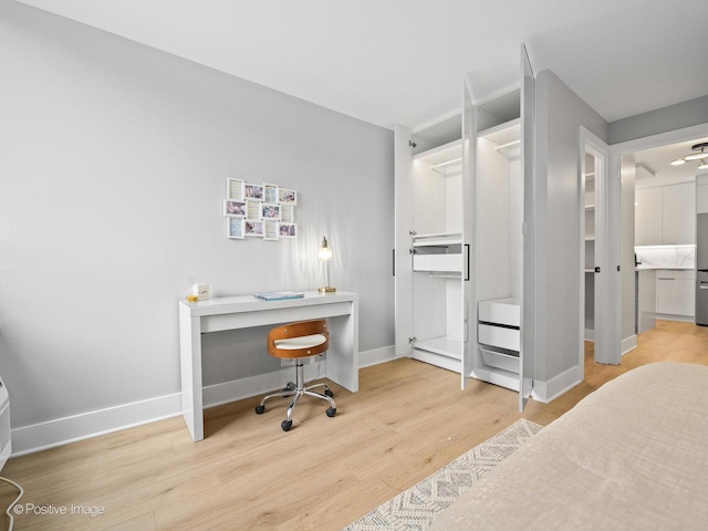 1455 N Sandburg Ter Unit 209B, Chicago, IL 60610 - bedroom featuring wood finished floors and an office area