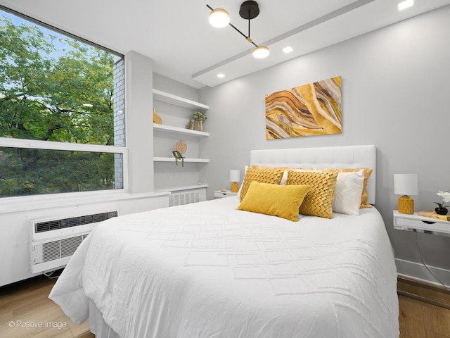 1455 N Sandburg Ter Unit 209B, Chicago, IL 60610 - bedroom featuring radiator, wood finished floors, recessed lighting, and an AC wall unit