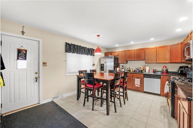 4301 Barry Ln, Oak Forest, IL 60452 - kitchen featuring appliances with stainless steel finishes, dark countertops, brown cabinets, recessed lighting, and light tile patterned floors