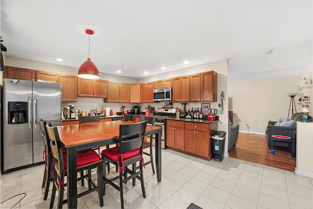 4301 Barry Ln, Oak Forest, IL 60452 - kitchen featuring appliances with stainless steel finishes, dark countertops, recessed lighting, decorative light fixtures, and brown cabinets