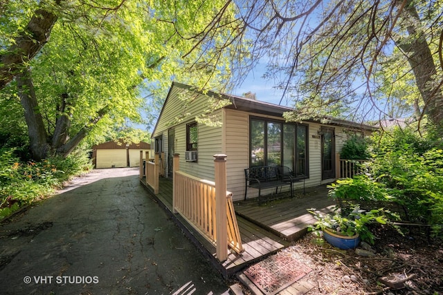 2506 Sigwalt St, Rolling Meadows, IL 60008 - view of side of home featuring a wooden deck, a garage, cooling unit, and an outdoor structure