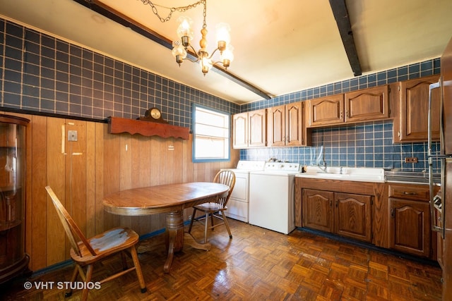 2506 Sigwalt St, Rolling Meadows, IL 60008 - kitchen featuring independent washer and dryer, a chandelier, brown cabinetry, beamed ceiling, and backsplash