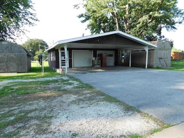 3411 Payson Rd, Quincy, IL 62305 - view of front facade with a detached garage, a barn, and a storage shed
