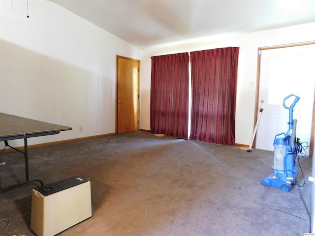 3411 Payson Rd, Quincy, IL 62305 - unfurnished living room featuring carpet flooring and baseboards