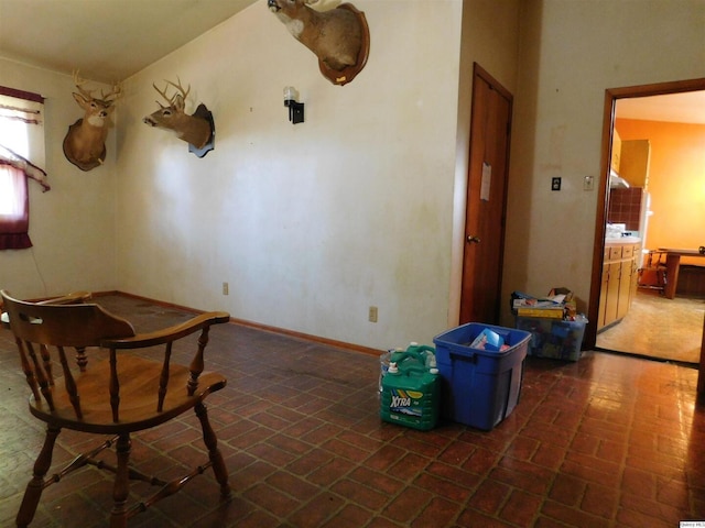 3411 Payson Rd, Quincy, IL 62305 - unfurnished dining area featuring brick patterned flooring and baseboards