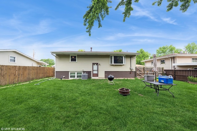 303 W 8th Pl, Hobart, IN 46342 - rear view of property with an outdoor fire pit and a fenced backyard