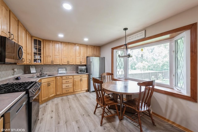 303 W 8th Pl, Hobart, IN 46342 - kitchen with appliances with stainless steel finishes, backsplash, light wood-type flooring, glass insert cabinets, and recessed lighting
