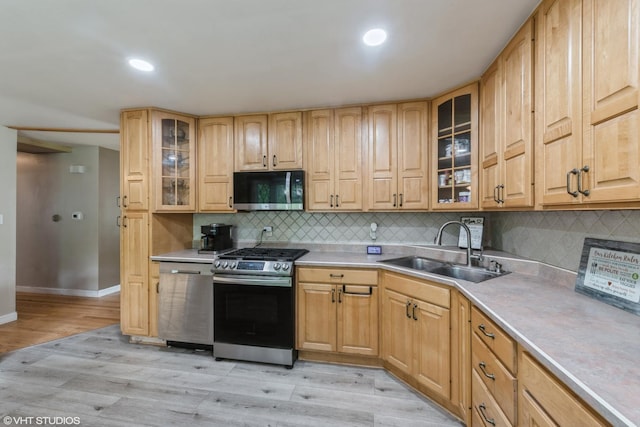 303 W 8th Pl, Hobart, IN 46342 - kitchen featuring appliances with stainless steel finishes, light wood-type flooring, decorative backsplash, light countertops, and recessed lighting