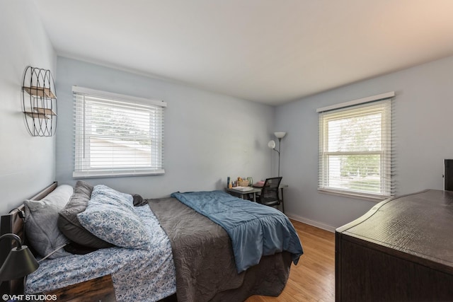 303 W 8th Pl, Hobart, IN 46342 - bedroom featuring multiple windows and light wood-style flooring