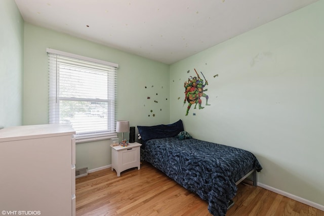 303 W 8th Pl, Hobart, IN 46342 - bedroom with light wood finished floors and baseboards