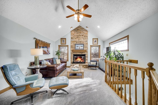 328 Windermere Dr, Chesterton, IN 46304 - carpeted living room featuring a ceiling fan, a textured ceiling, vaulted ceiling, a stone fireplace, and recessed lighting