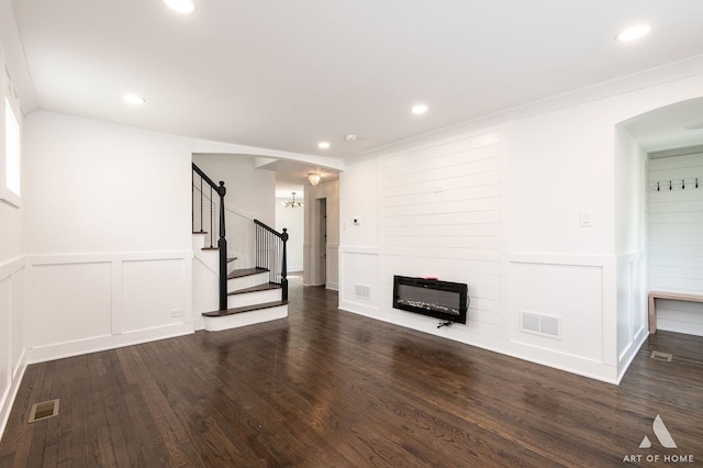 9156 S Sawyer Ave, Evergreen Park, IL 60805 - unfurnished living room featuring wood finished floors, stairs, arched walkways, recessed lighting, and a decorative wall