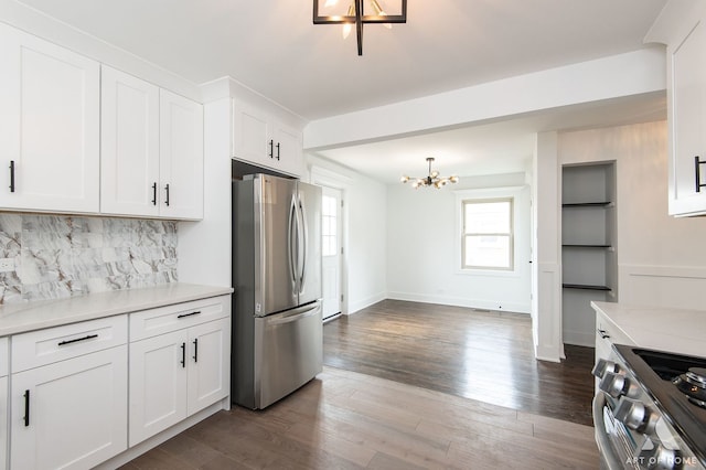 9156 S Sawyer Ave, Evergreen Park, IL 60805 - kitchen with appliances with stainless steel finishes, a chandelier, backsplash, light countertops, and white cabinetry