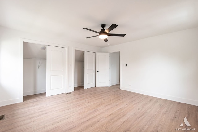 9156 S Sawyer Ave, Evergreen Park, IL 60805 - unfurnished bedroom featuring two closets, light wood-style floors, and a ceiling fan
