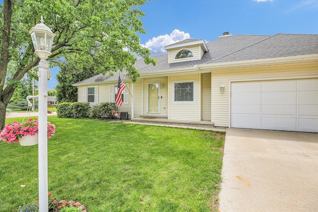 1901 Sumac Dr, Champaign, IL 61821 - traditional-style home featuring driveway, a front yard, roof with shingles, and a garage