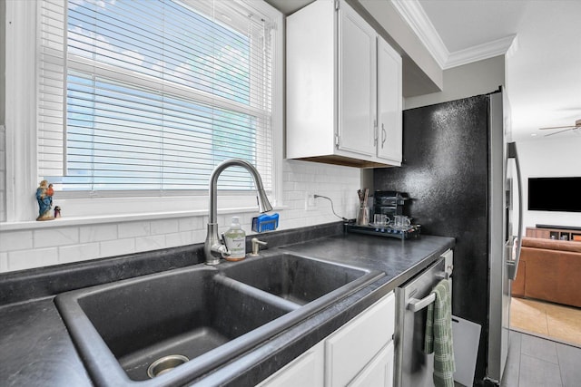 1901 Sumac Dr, Champaign, IL 61821 - kitchen featuring dark countertops, ornamental molding, appliances with stainless steel finishes, white cabinets, and plenty of natural light