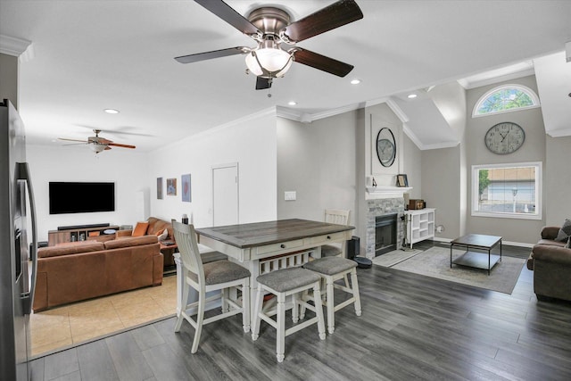 1901 Sumac Dr, Champaign, IL 61821 - dining area featuring a ceiling fan, a fireplace, wood finished floors, recessed lighting, and ornamental molding