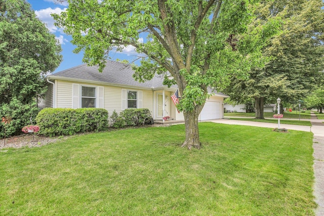 1901 Sumac Dr, Champaign, IL 61821 - view of front facade featuring concrete driveway, a garage, a front lawn, and a shingled roof