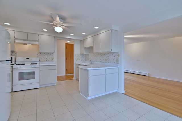 6959 W Higgins Ave Unit 3S, Chicago, IL 60656 - kitchen featuring gas range gas stove, a baseboard radiator, under cabinet range hood, light countertops, and a ceiling fan