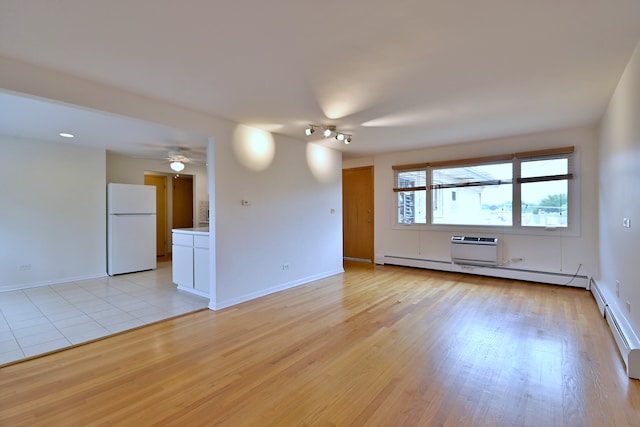 6959 W Higgins Ave Unit 3S, Chicago, IL 60656 - empty room with light wood-style flooring, a baseboard heating unit, and ceiling fan