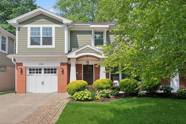 806 S Walnut Ave, Arlington Heights, IL 60005 - view of front of house with brick siding, driveway, an attached garage, and a front yard