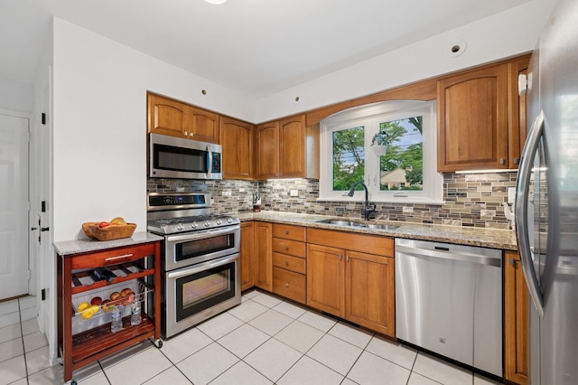 806 S Walnut Ave, Arlington Heights, IL 60005 - kitchen with stainless steel appliances, light stone counters, decorative backsplash, and brown cabinets