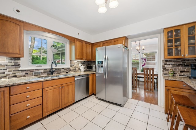 806 S Walnut Ave, Arlington Heights, IL 60005 - kitchen featuring stainless steel appliances, a chandelier, brown cabinets, and tasteful backsplash