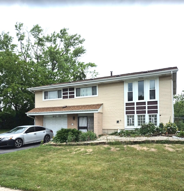 3208 172nd Ct, Hazel Crest, IL 60429 - view of front of property featuring driveway, a garage, and a front yard