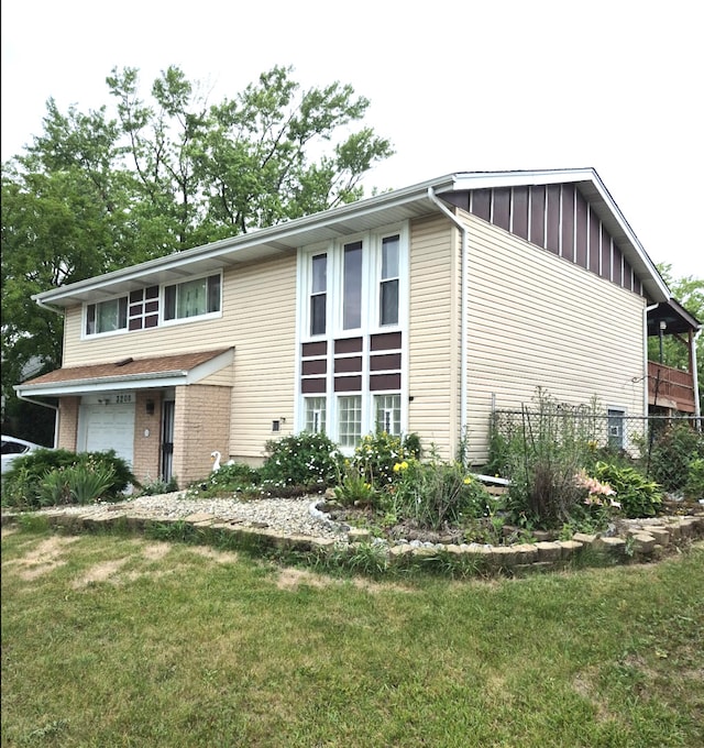 3208 172nd Ct, Hazel Crest, IL 60429 - view of front facade featuring a garage, board and batten siding, and brick siding