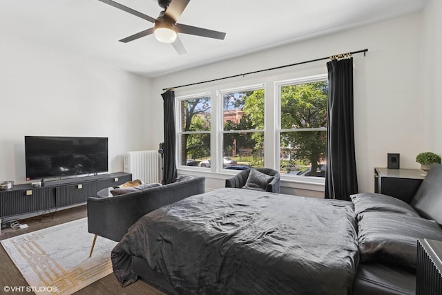 1709 W Wallen Ave Unit 1J, Chicago, IL 60626 - bedroom with radiator, wood finished floors, and a ceiling fan