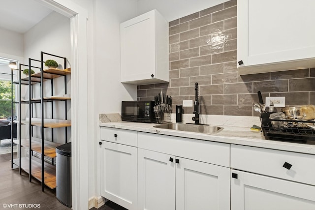 1709 W Wallen Ave Unit 1J, Chicago, IL 60626 - kitchen featuring backsplash, black microwave, dark wood-type flooring, and white cabinets