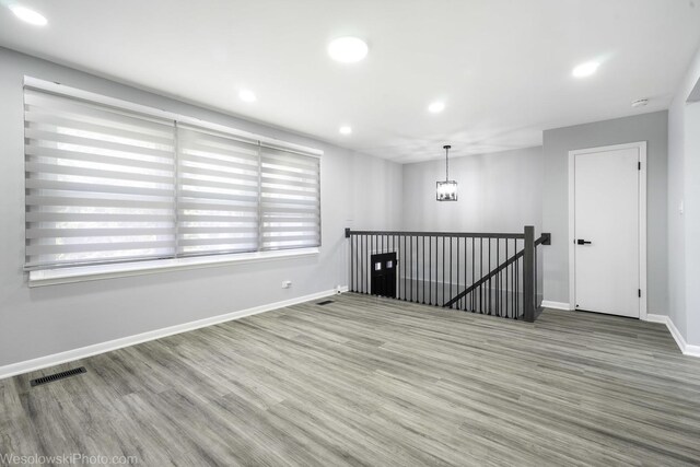 651 Clearmont Dr, Elk Grove Village, IL 60007 - unfurnished room featuring wood finished floors, a smoke detector, recessed lighting, and a chandelier
