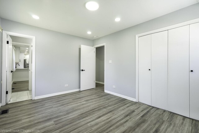 651 Clearmont Dr, Elk Grove Village, IL 60007 - unfurnished bedroom featuring wood finished floors, a closet, recessed lighting, and connected bathroom