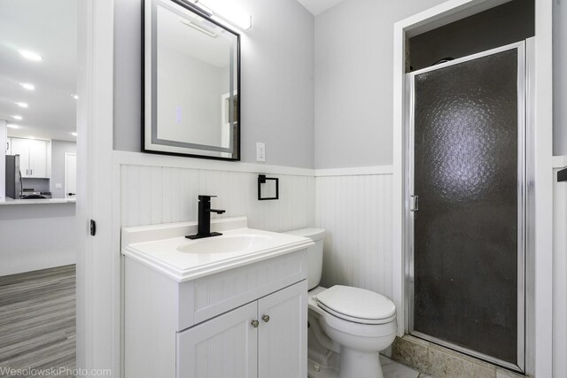 651 Clearmont Dr, Elk Grove Village, IL 60007 - bathroom featuring wainscoting, a stall shower, and vanity