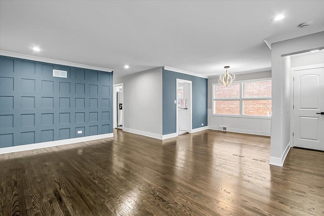 9007 S Cregier Ave, Chicago, IL 60617 - unfurnished living room featuring a chandelier, dark wood-style flooring, ornamental molding, recessed lighting, and a decorative wall