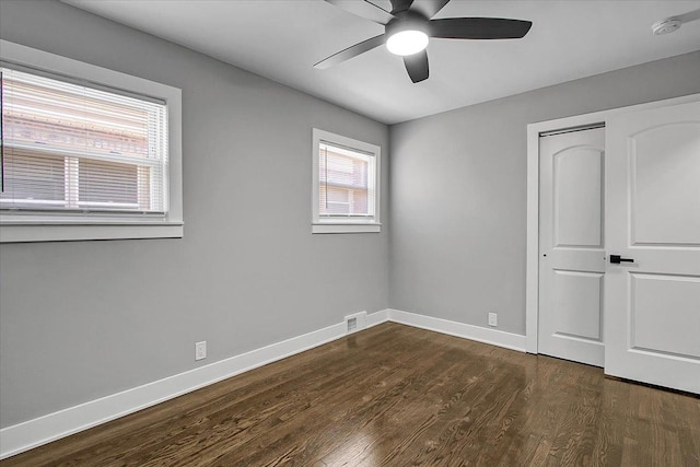 9007 S Cregier Ave, Chicago, IL 60617 - unfurnished bedroom featuring dark wood-style flooring, a closet, and a ceiling fan